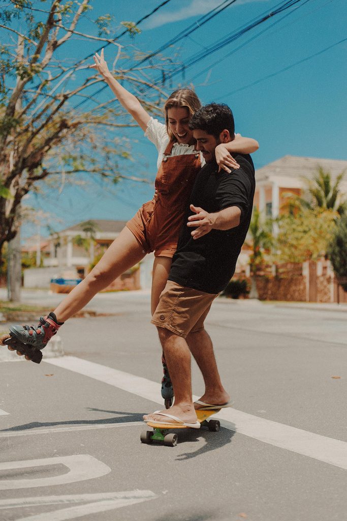 pexels-photo-4394970-4394970 Happy couple experiencing joy and leisure while skateboarding together outdoors in Rio de Janeiro.